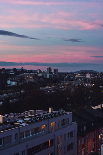 A vibrant African city skyline at dusk with solar panels and green tech installations glowing softly.