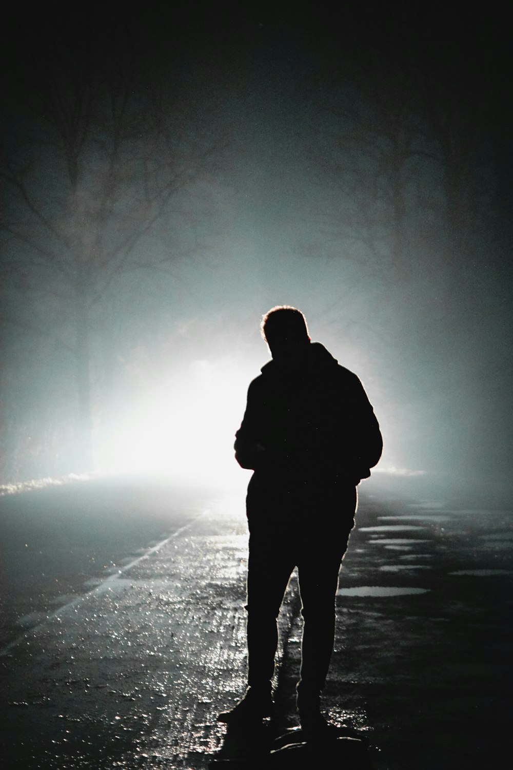a person standing on a street in the dark