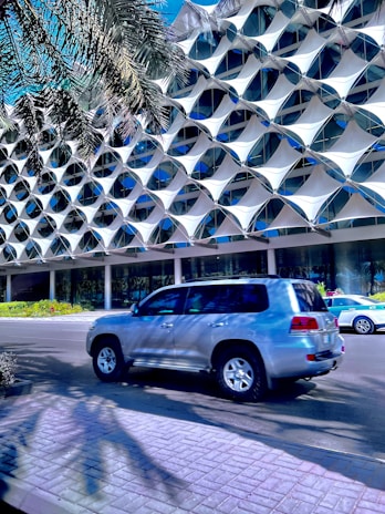 a silver suv parked in front of a building