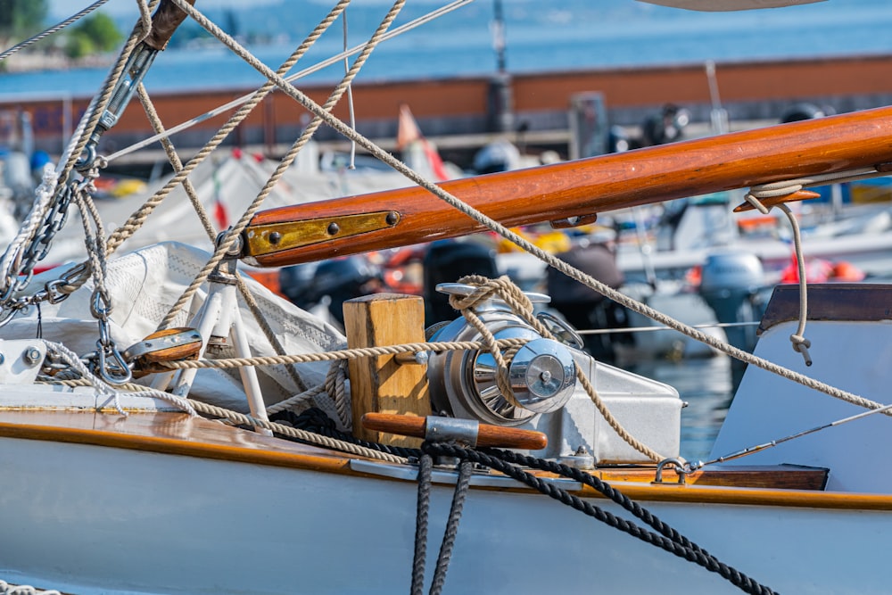 a close up of a sailboat with a lot of other boats in the background