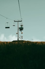 a couple of chairs sitting on top of a hill