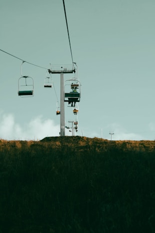 a couple of chairs sitting on top of a hill