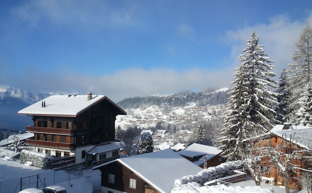 a view of a snowy mountain with a house in the foreground