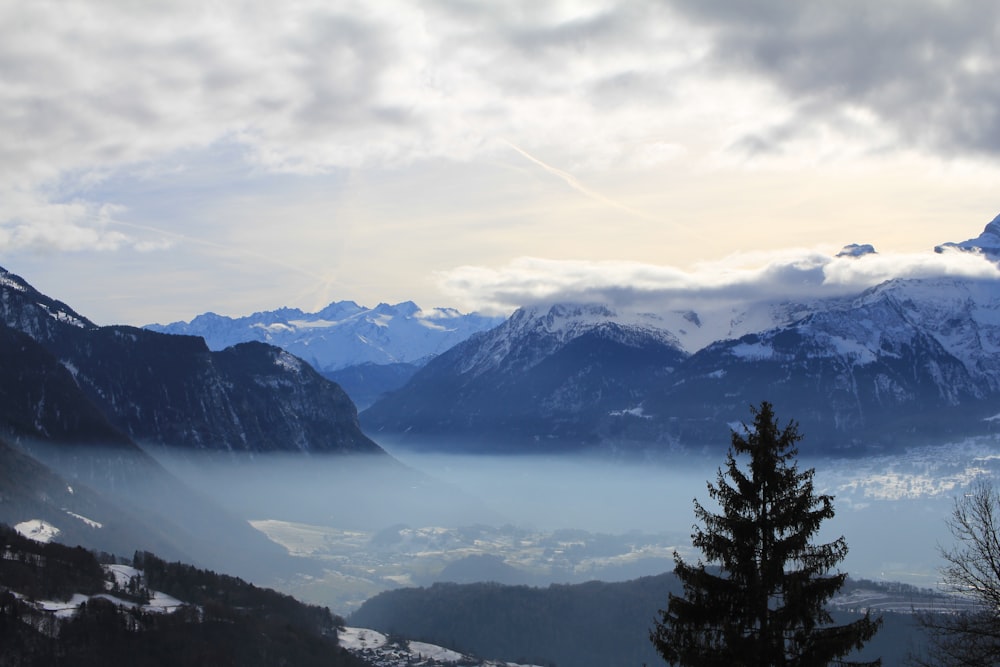 a view of a mountain range with a lake in the foreground