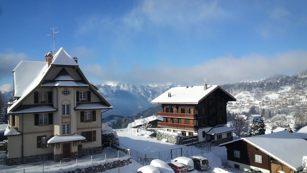 a snow covered town with a mountain in the background