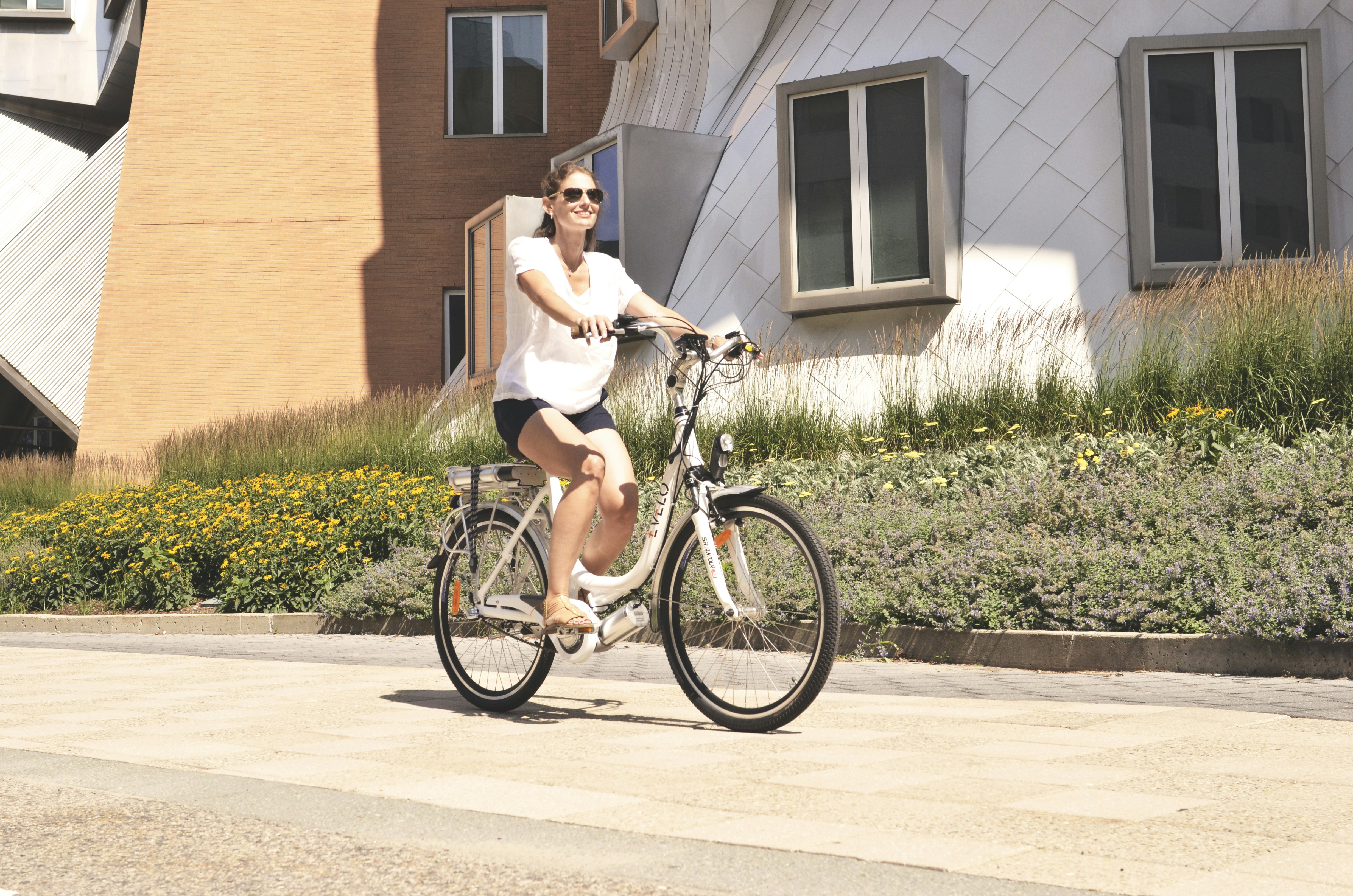 a woman riding a bike on a city street