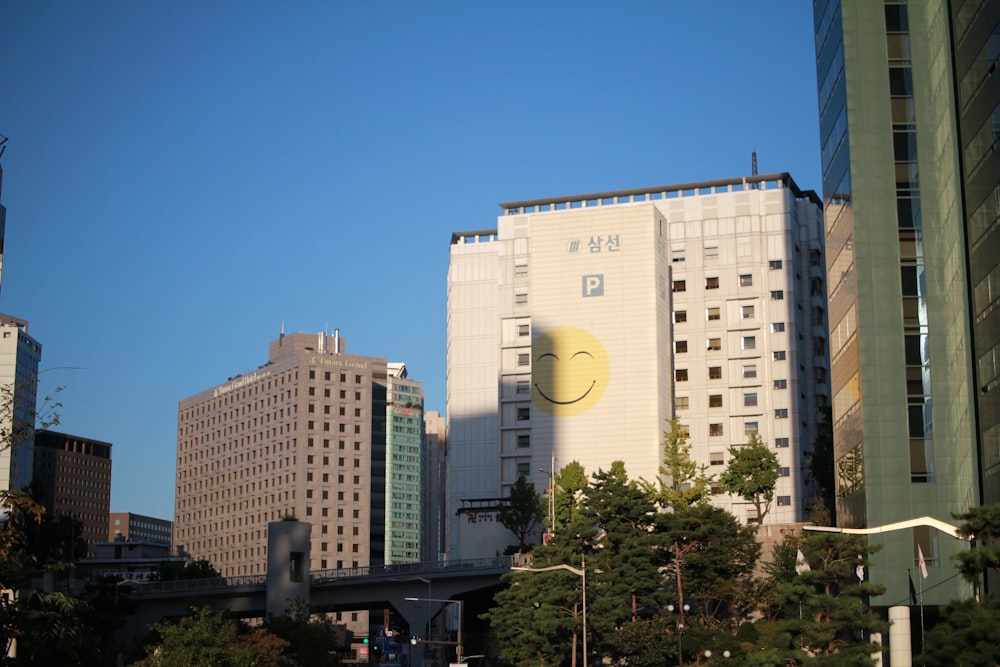 a yellow smiley face on a building in a city
