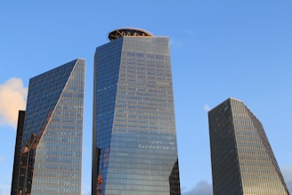 two skyscrapers in a city with a blue sky in the background