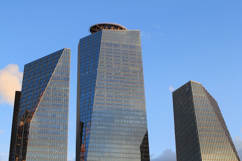 two skyscrapers in a city with a blue sky in the background