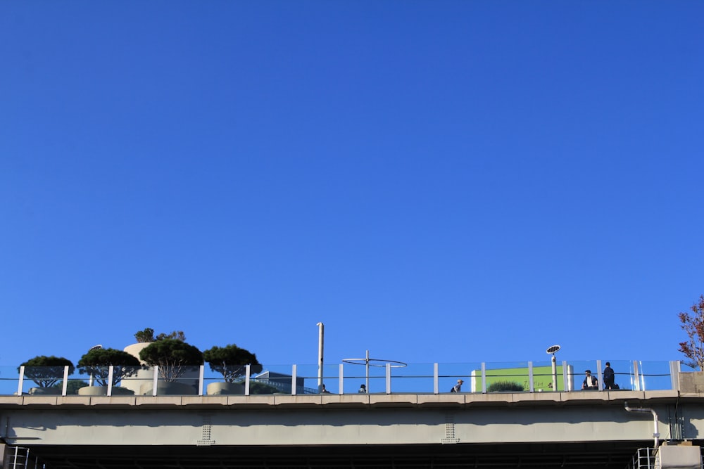 a group of people standing on top of a bridge