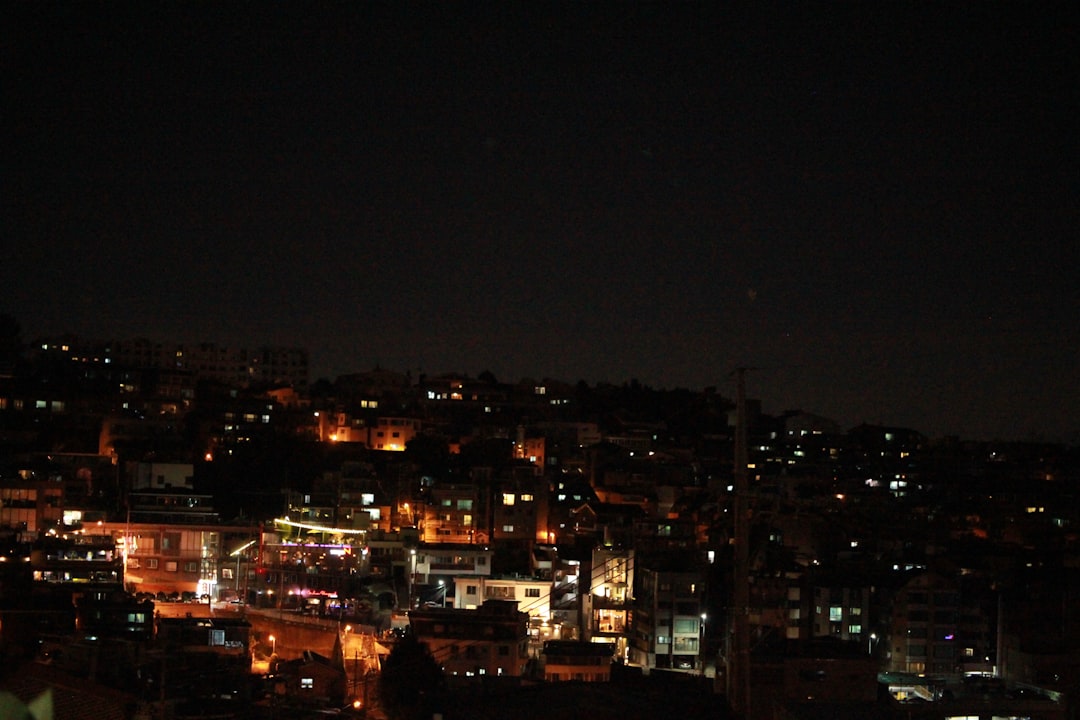 a night view of a city with buildings lit up,
