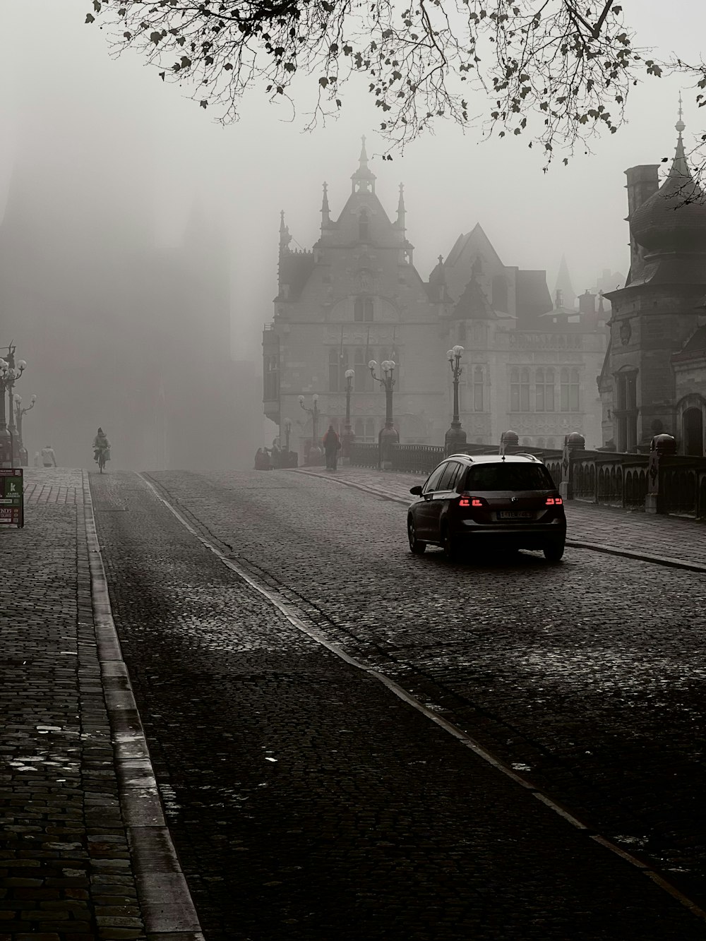 a car is driving down a foggy street
