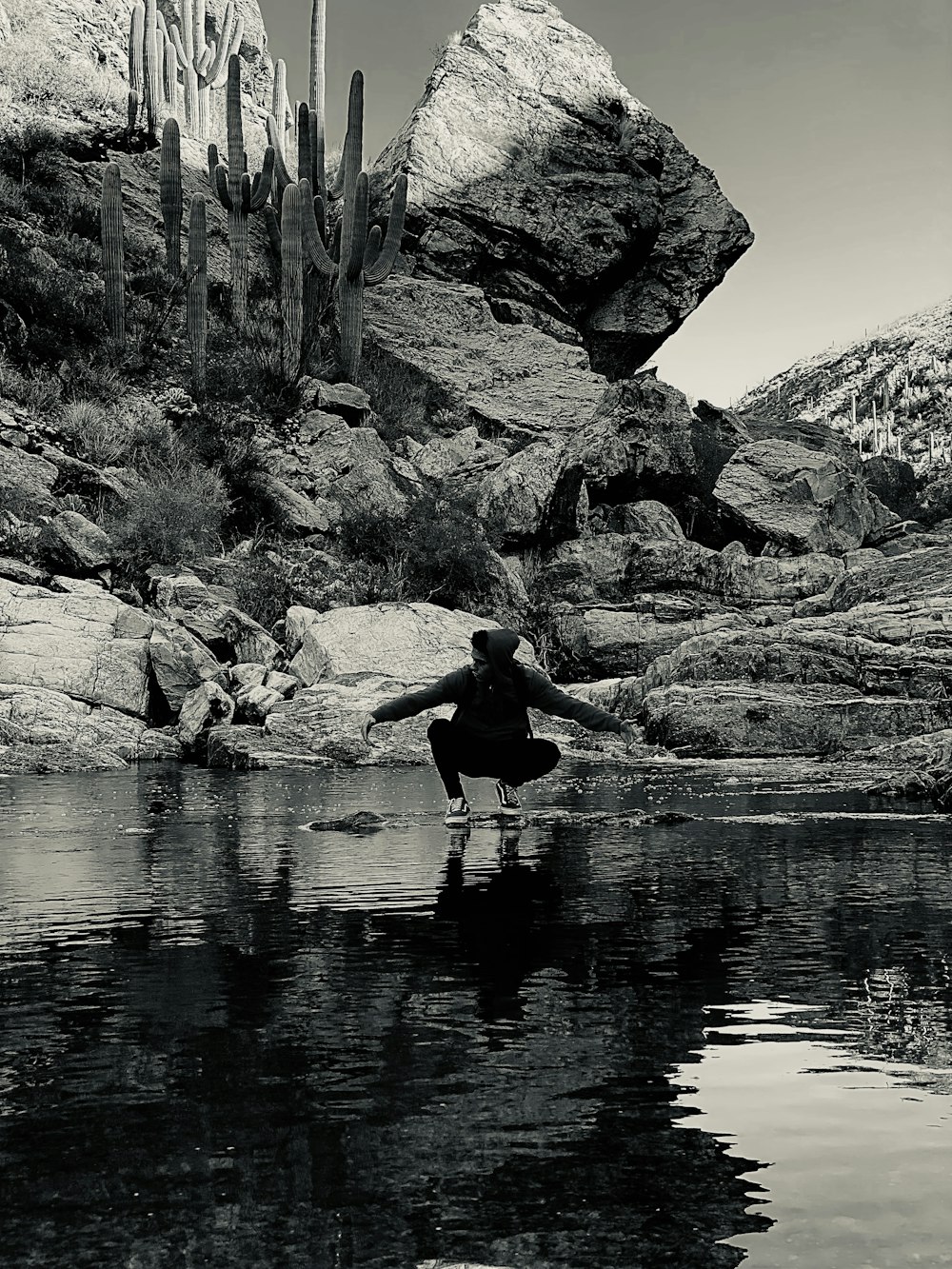 a black and white photo of a person in the water