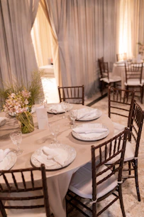 An elegant round dining set with upholstered chairs, perfect for intimate dinners.
