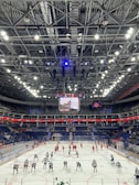 Evening practice with players skating hard under the arena lights.