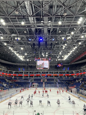 Evening practice with players skating hard under the arena lights.