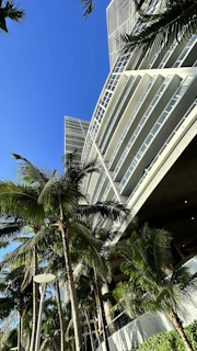 Modern Alphaville condominium residence with lush gardens and spacious terraces under clear blue skies.