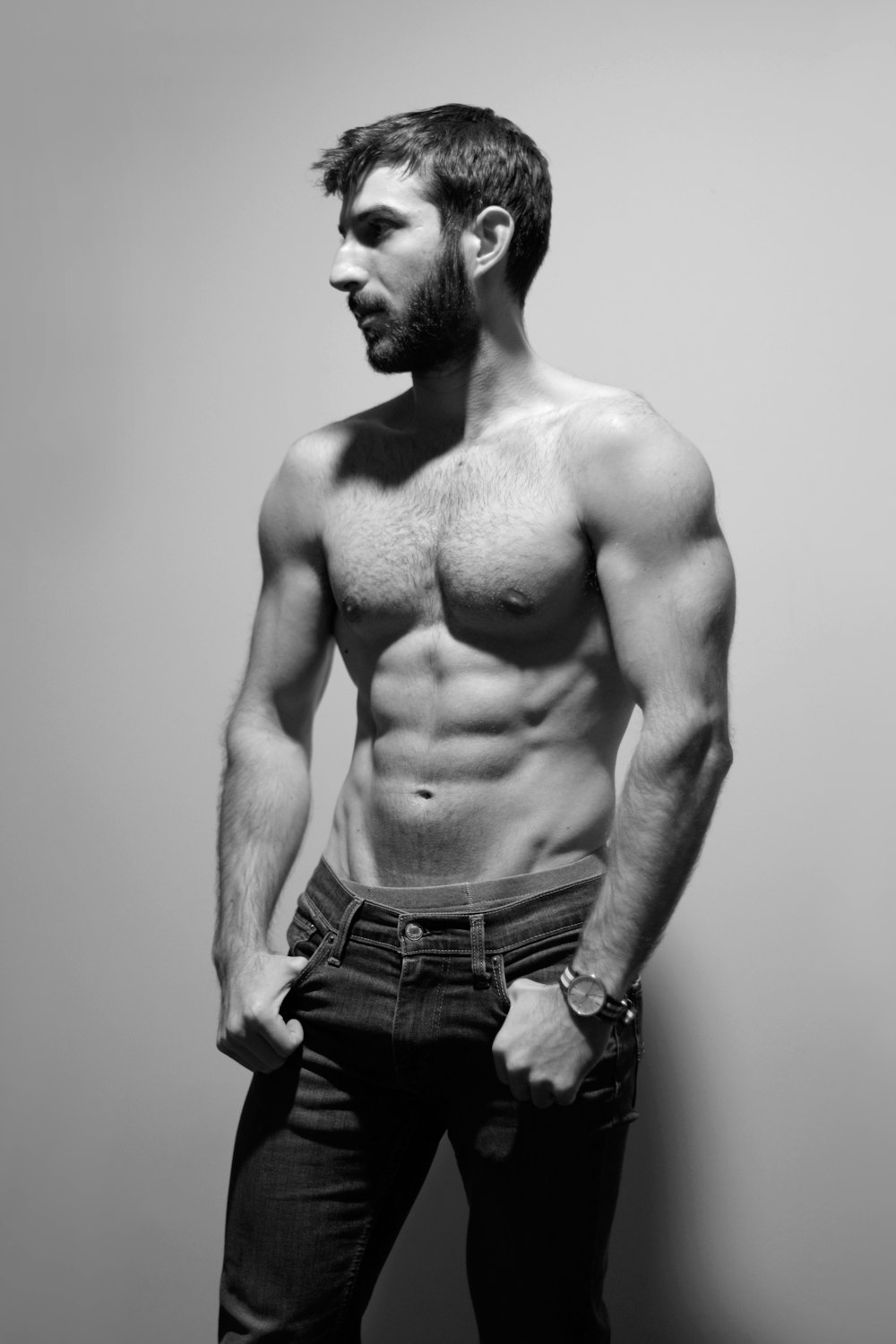 a man with a beard and no shirt posing for a picture