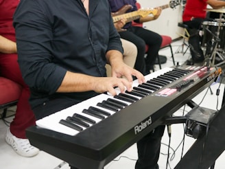 a man playing a keyboard in front of a microphone