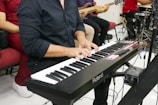 a man playing a keyboard in front of a microphone