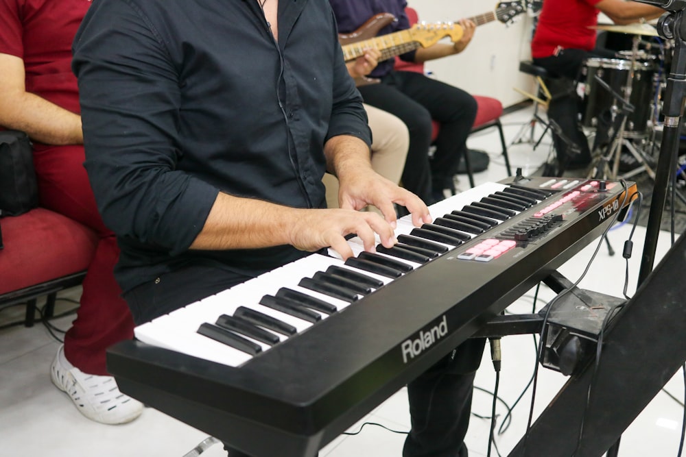 a man playing a keyboard in front of a microphone