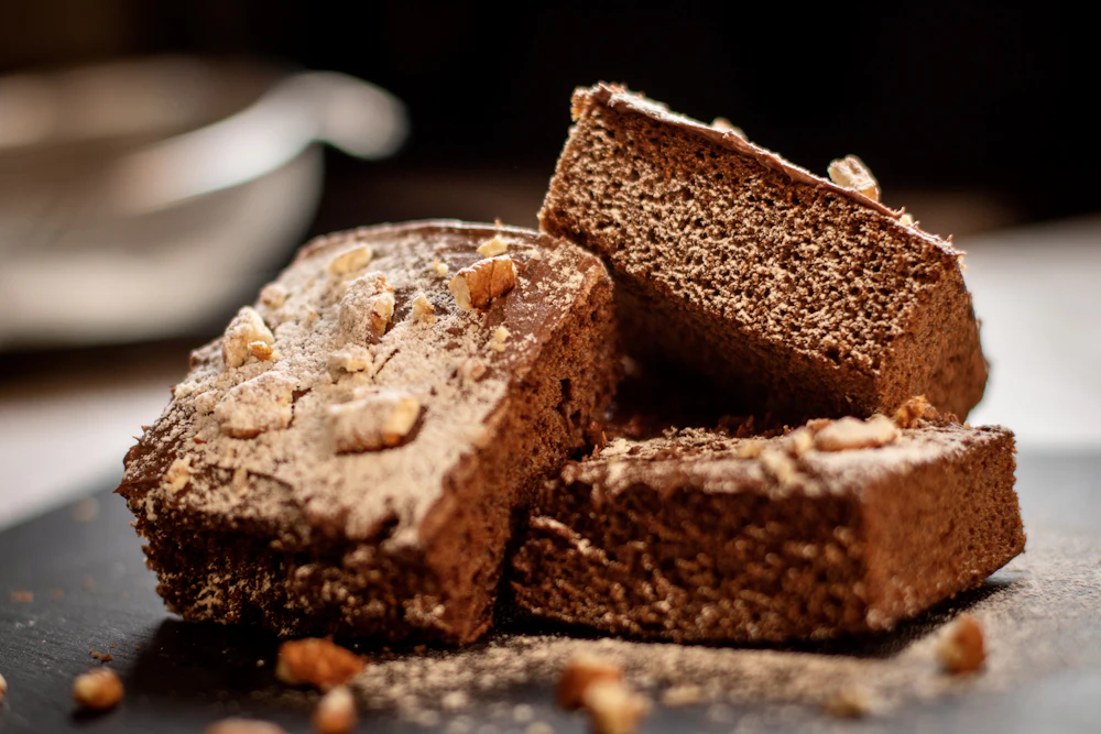 Dark chocolate brownies stacked on a table