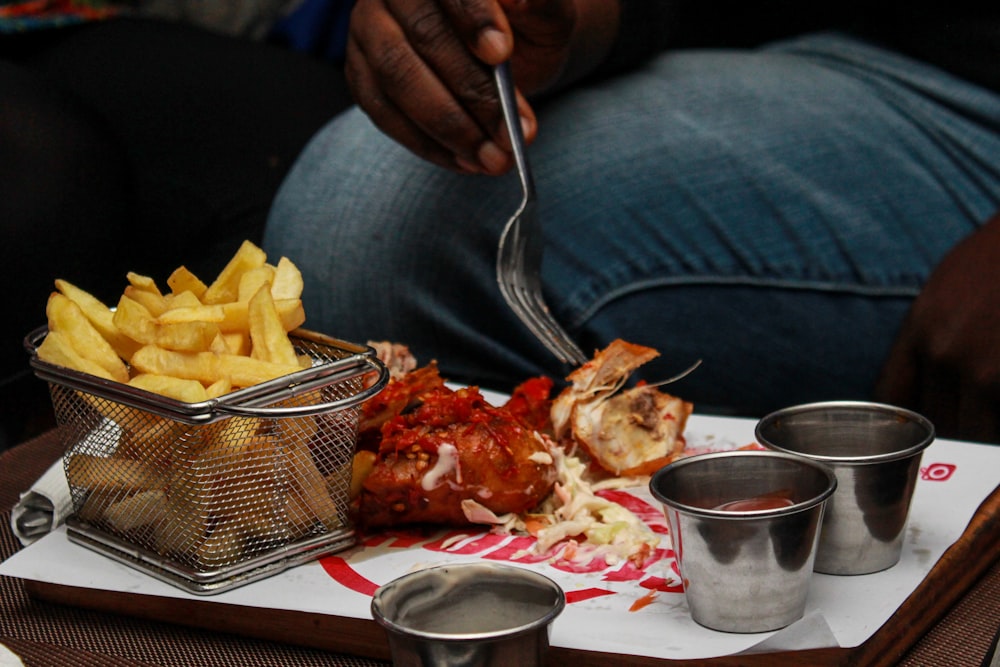 a person sitting at a table with a tray of food