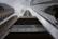 A dramatic perspective of tall, modern skyscrapers converging towards the cloudy sky. The dark tones and reflections on the building surfaces highlight the height and architectural style. The prominent branding of IBM is visible on one of the buildings, creating a strong corporate presence.