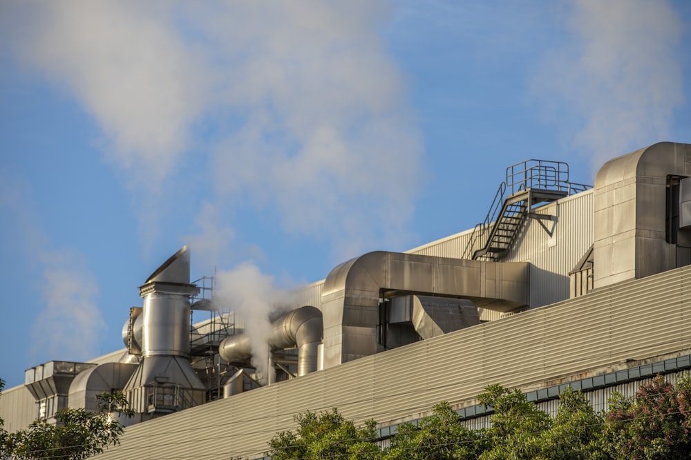 smoke billows from the stacks of industrial smokestacks