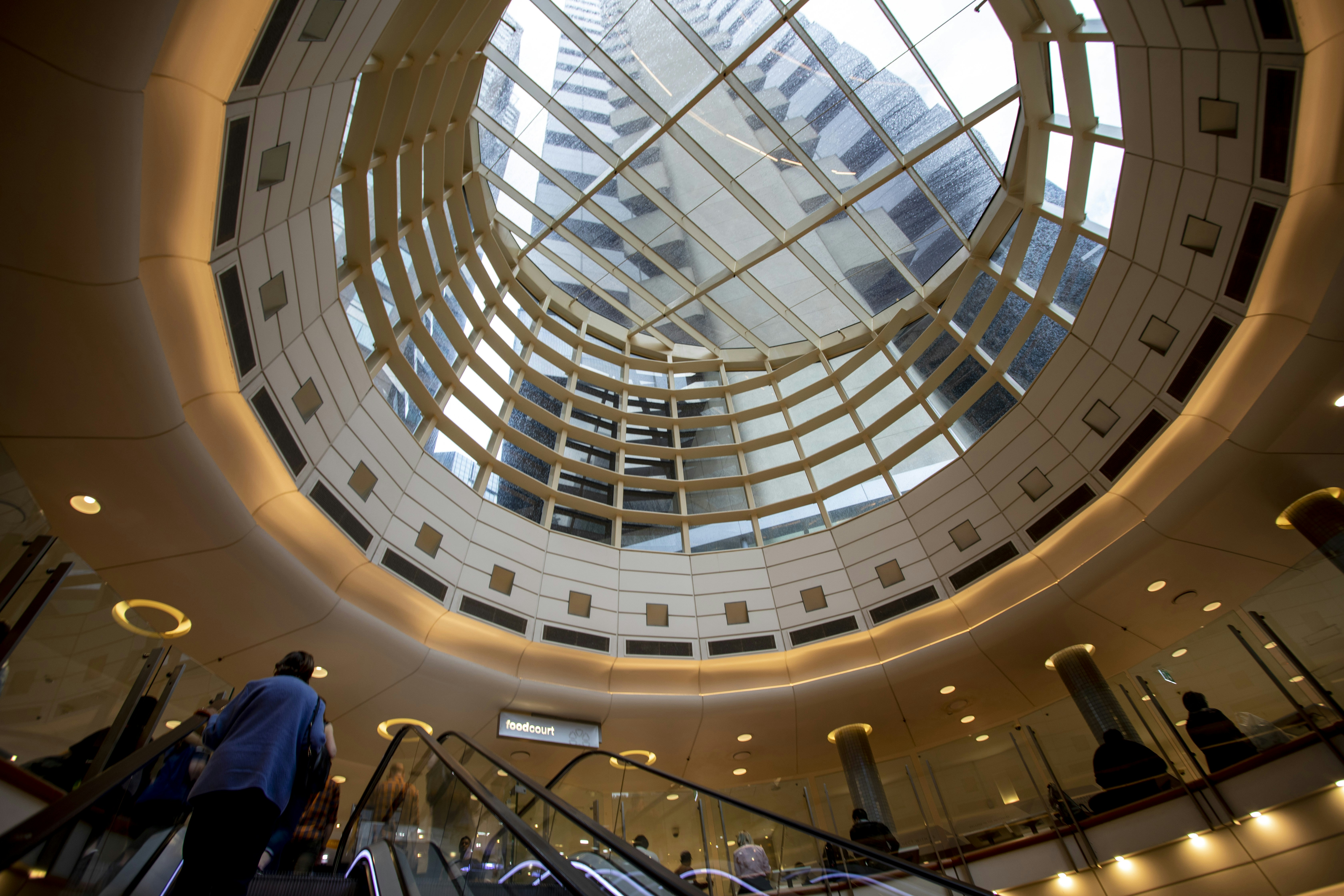 Escalator beneath a round skylight in a shopping centre