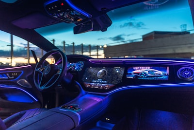 the interior of a car with blue lights