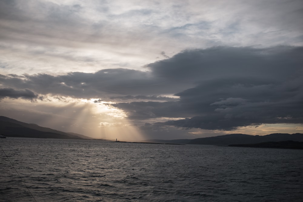 a large body of water under a cloudy sky