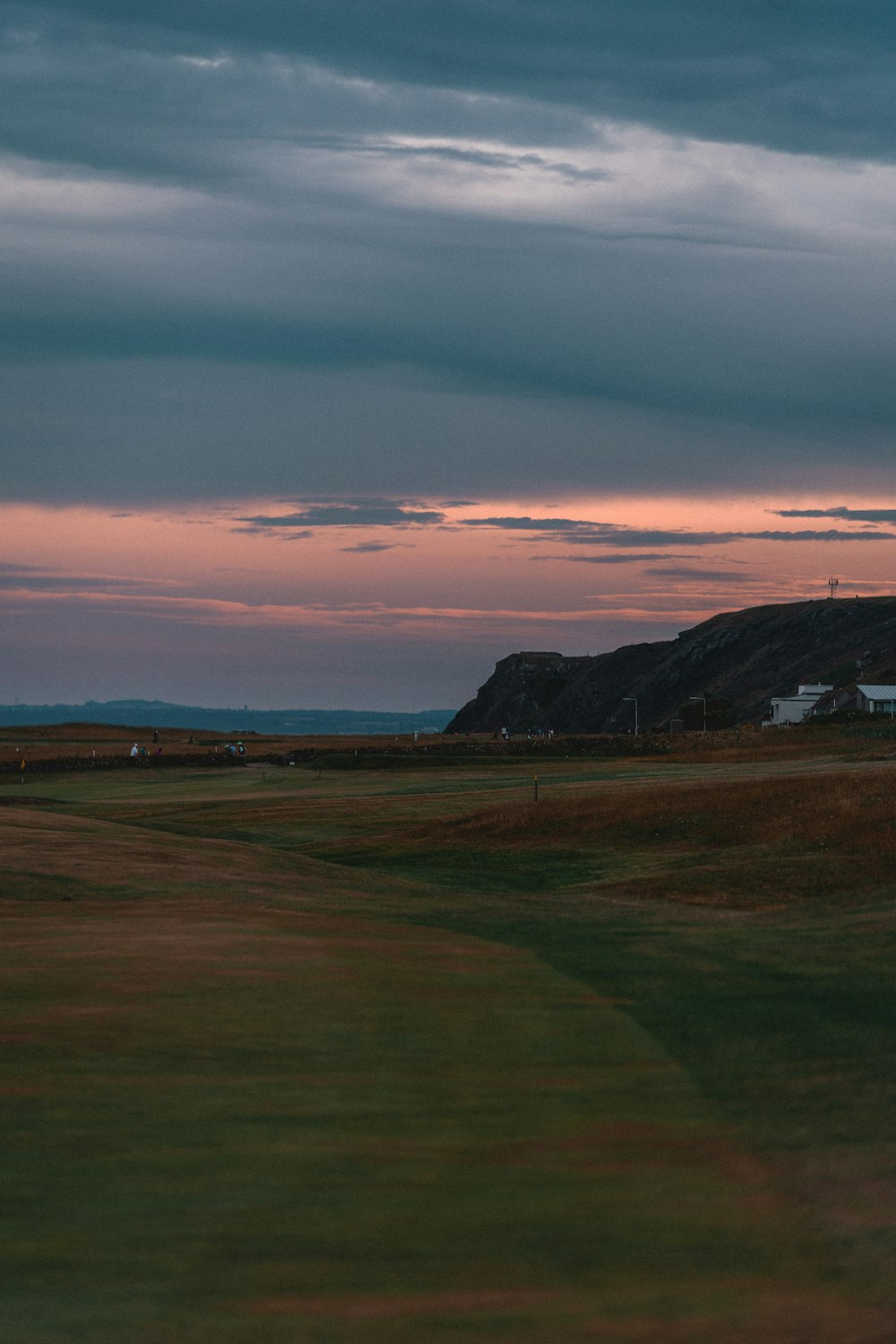 a view of a golf course at sunset
