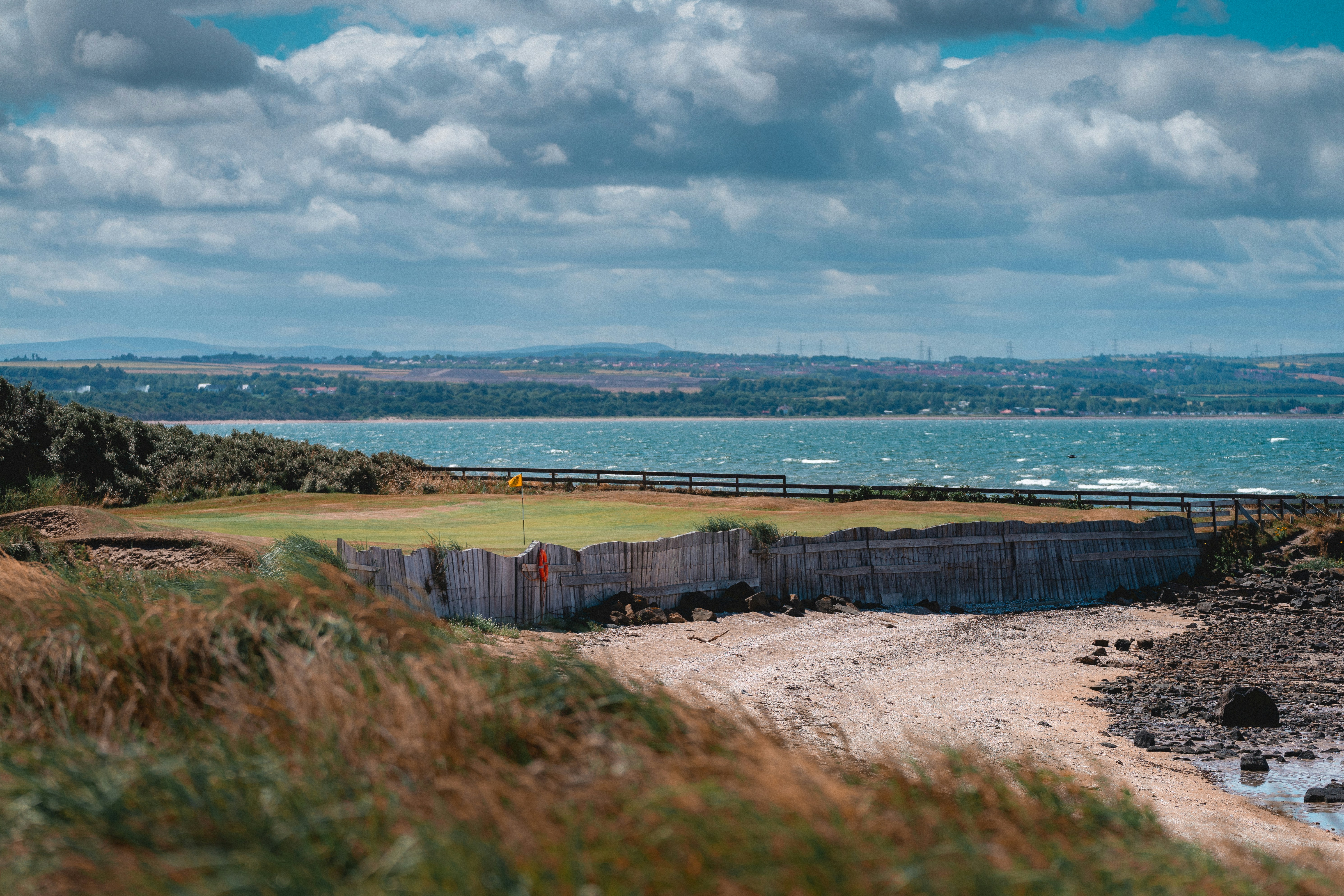 a view of a golf course near a body of water
