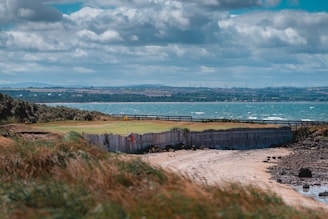 a view of a golf course near a body of water