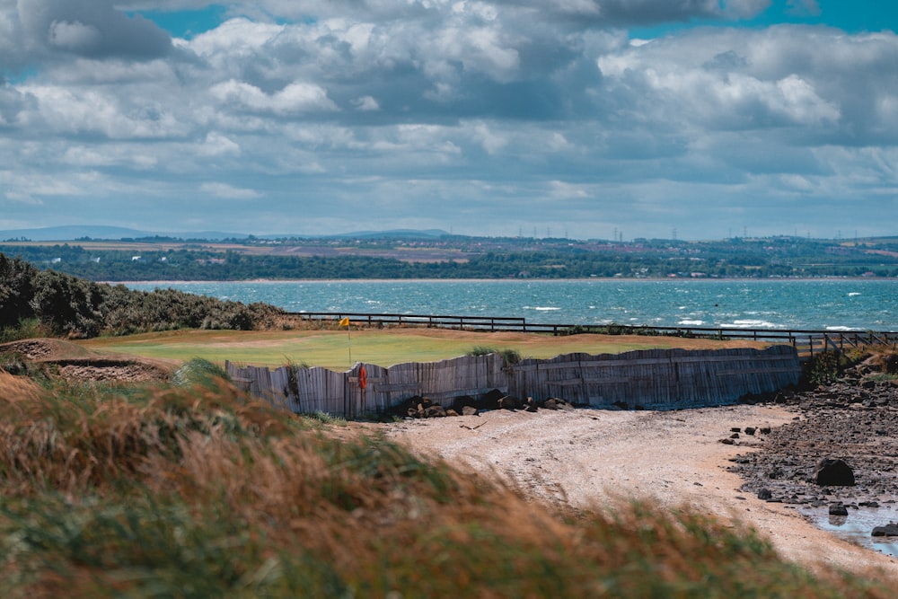 a view of a golf course near a body of water