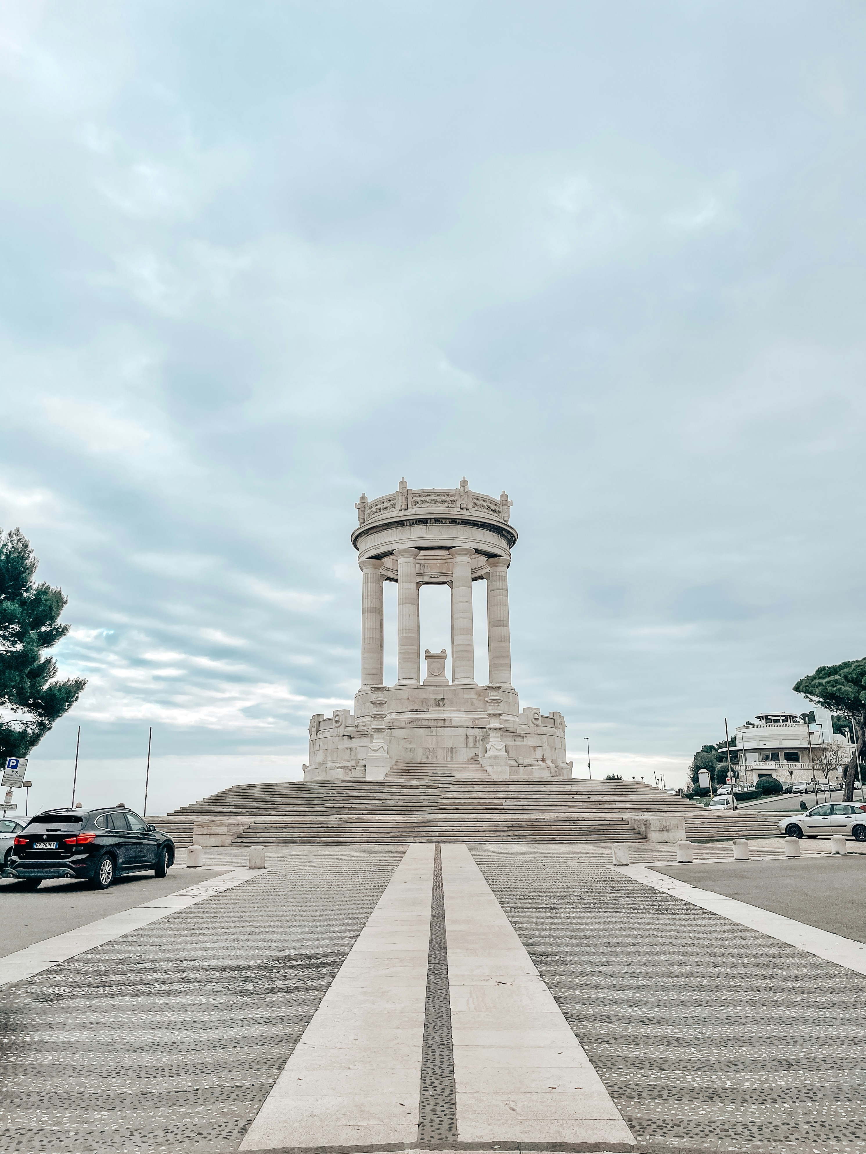 a car is parked in front of a monument