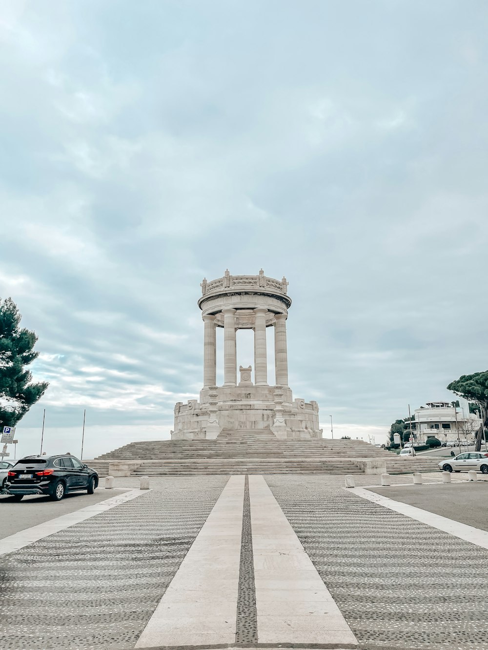 a car is parked in front of a monument