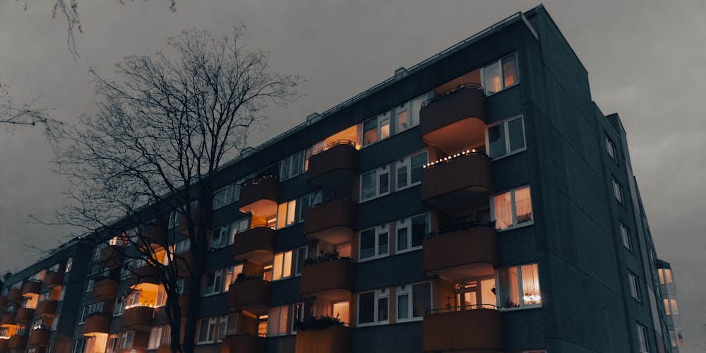 a tall building with lots of windows at night