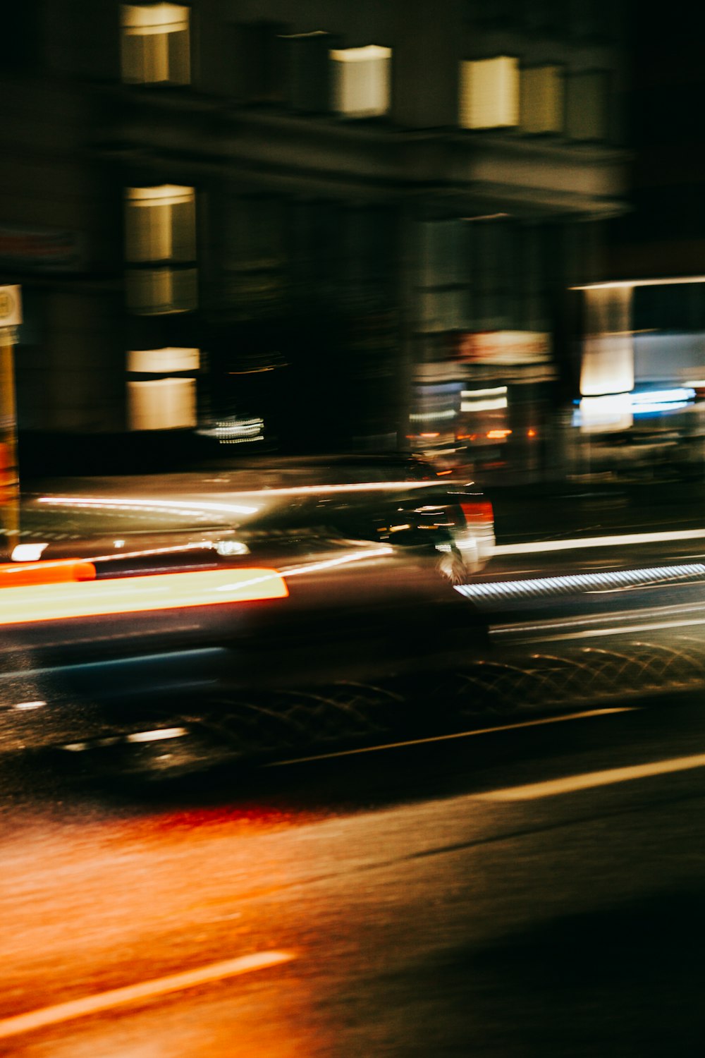 a car driving down a street at night