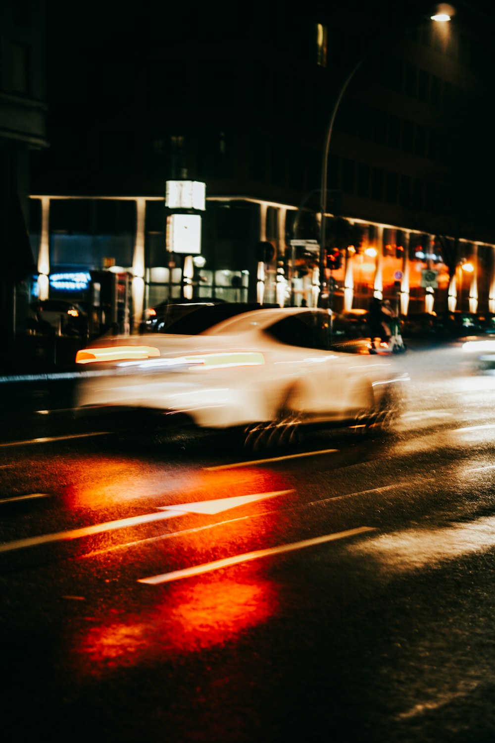 a car driving down a street at night