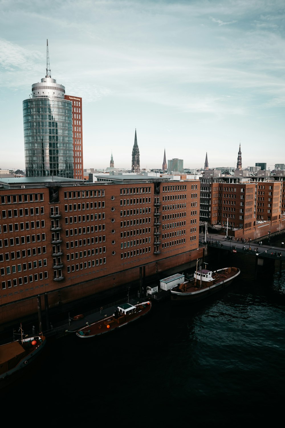 a large brick building next to a body of water