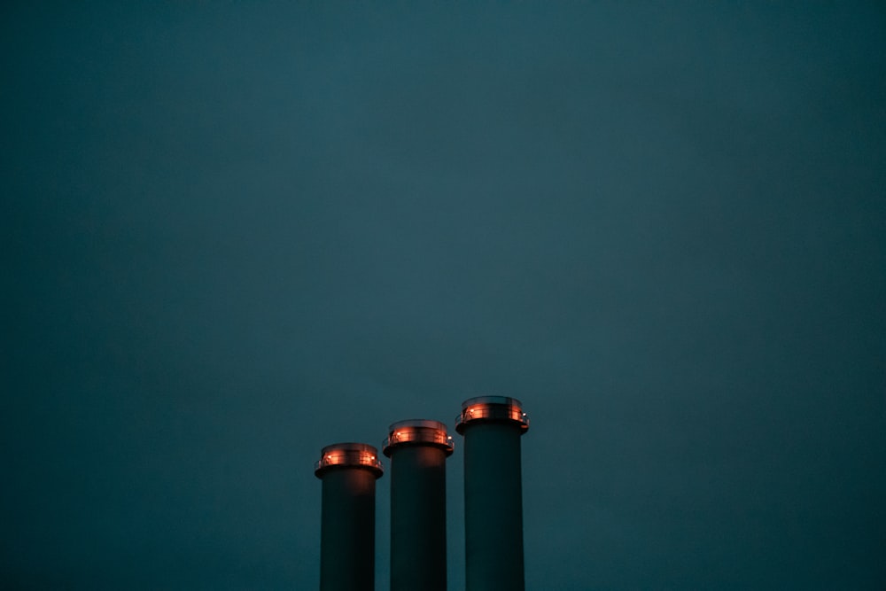 a group of three metal tubes sitting next to each other