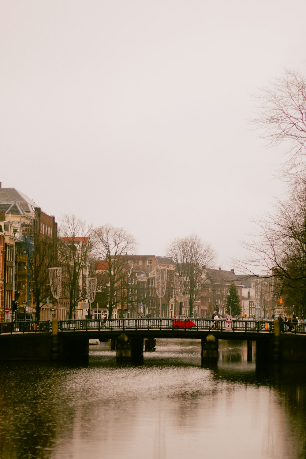 a bridge over a body of water with buildings in the background