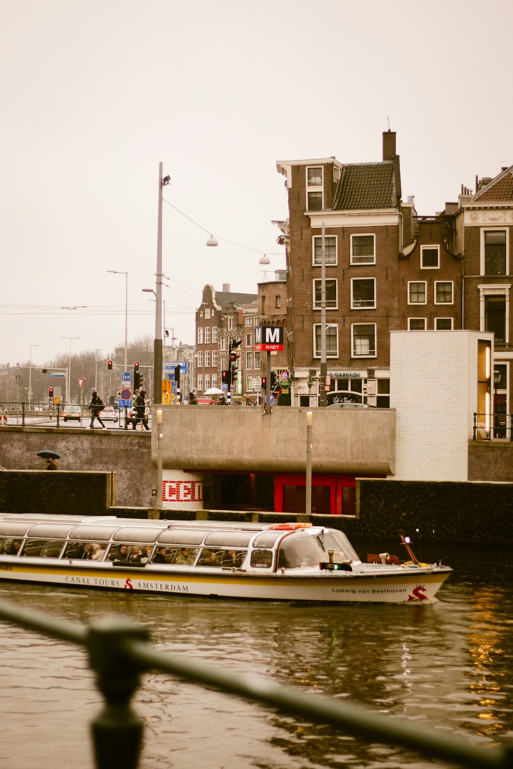 a boat traveling down a river next to a bridge