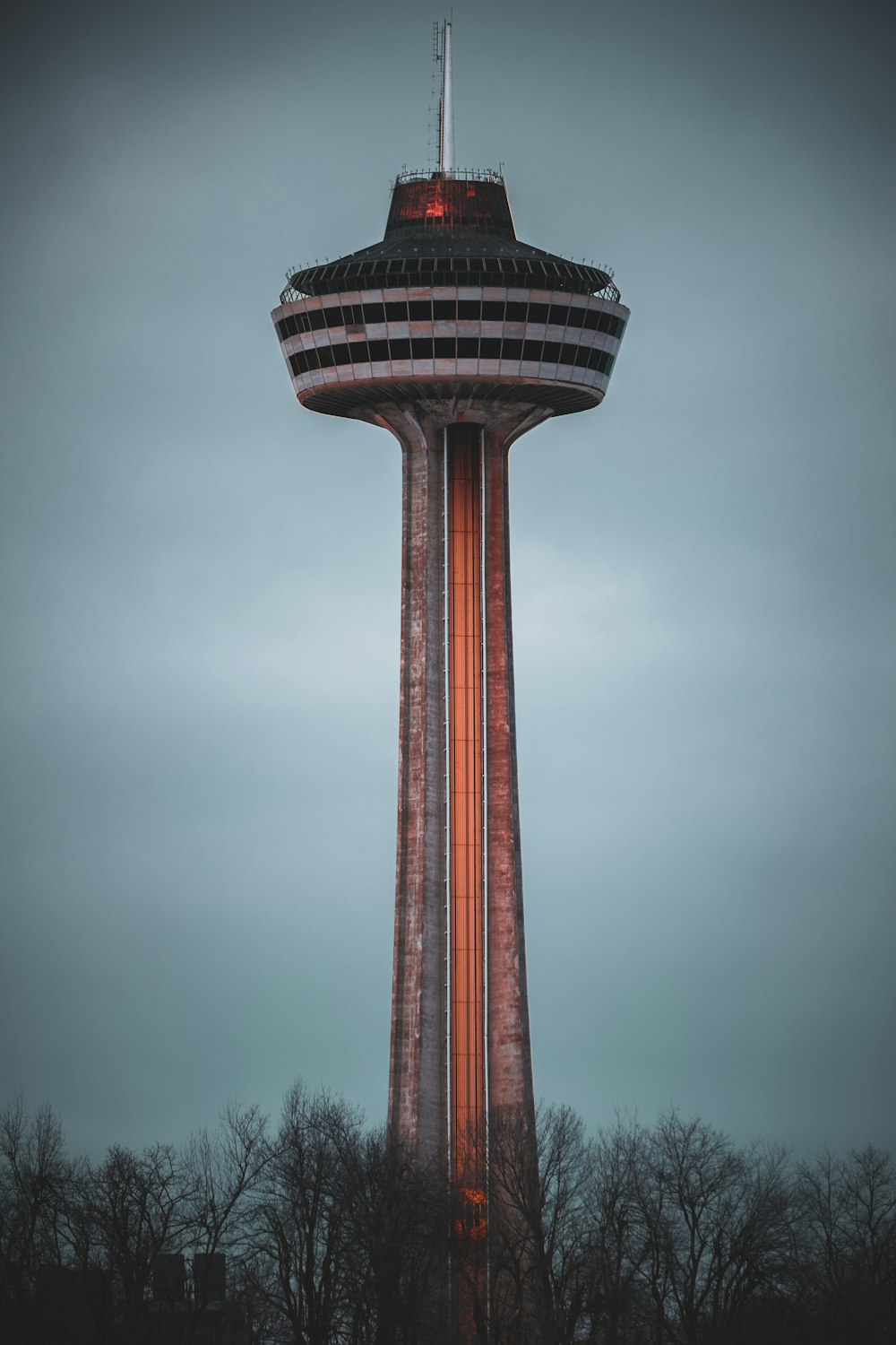 a very tall tower with a clock on it's side