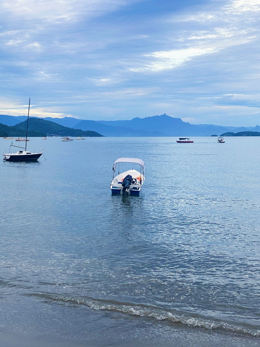 a small boat floating on top of a body of water