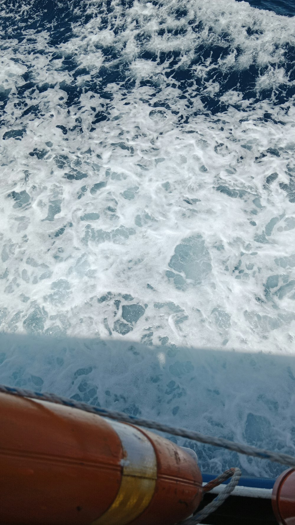 a view of the back of a boat in the water
