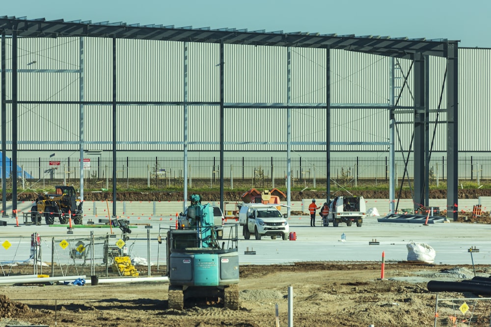 a construction site with a large building in the background