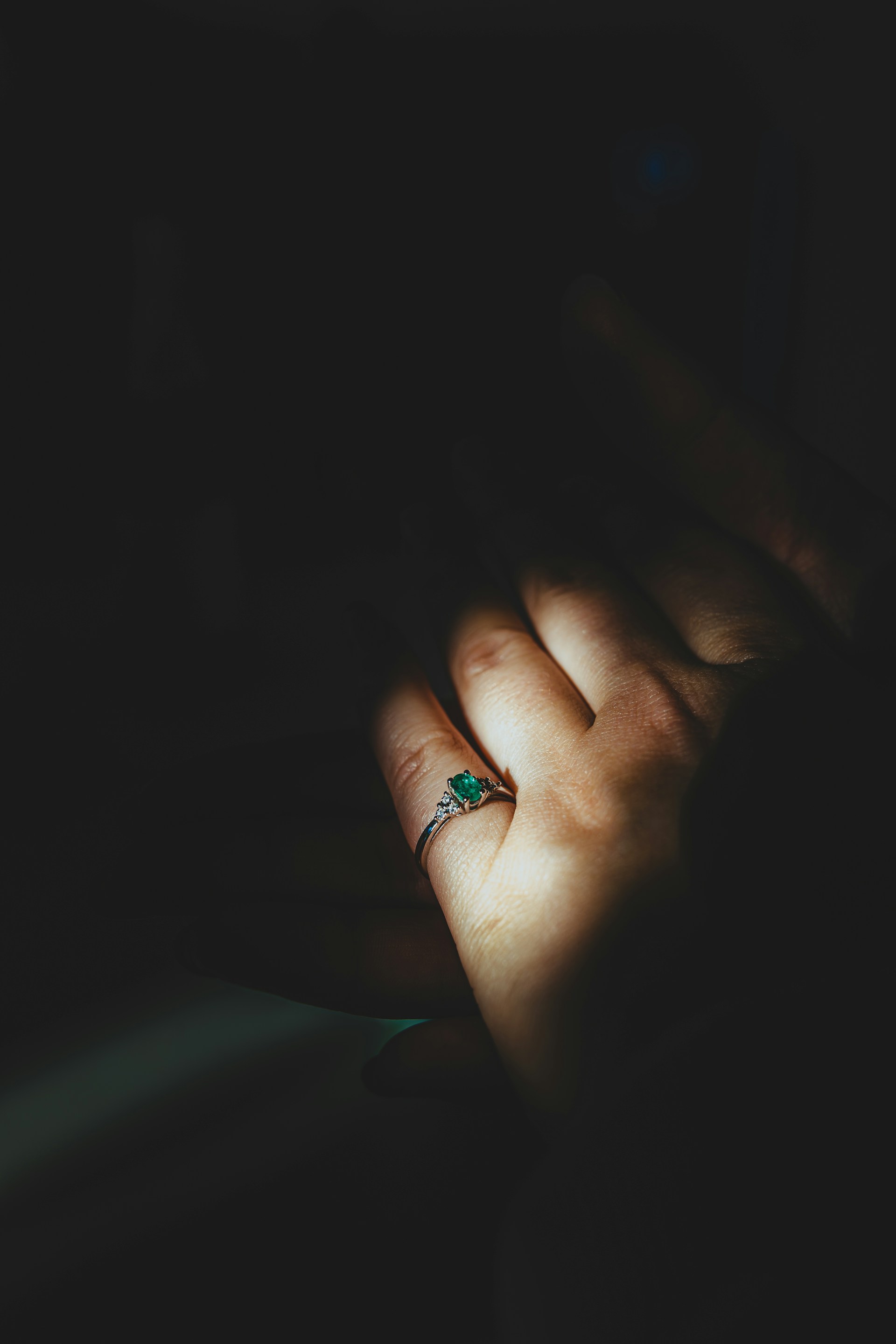 a person's hand with a ring on it
